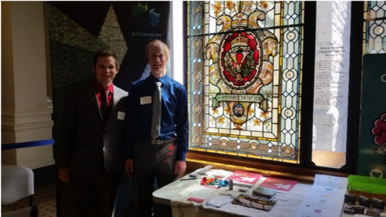 Danny and Kaden standing by a stained glass window